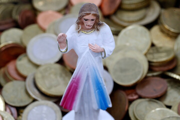 Catholic finance and economy concept. Jesus and  euro coins. France.