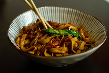 Fresh chineese noodle with beef and chopsticks. 