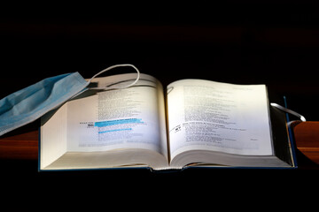 Catholic church. Bible, surgical mask. Covid-19 epidemic.
