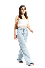 Modern trendy cool happy woman in street style clothes walking and smiling in hard light. Full body length isolated on white background