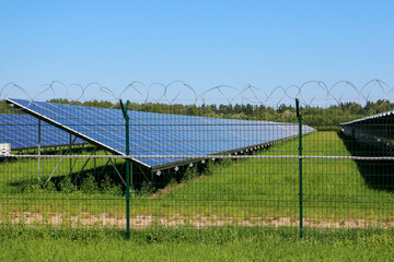Solar panel on the field behind the barbed wire