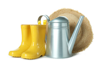 Watering can, rubber boots and straw hat isolated on white background © Atlas