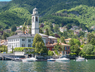 Fototapeta na wymiar village of Cernobbio immersed in the green of the mountains and overlooking Como lake.Lombardy, Italy.