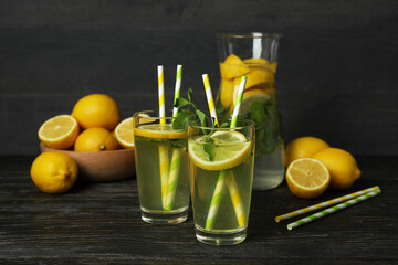 Glasses with fresh lemonade on wooden table