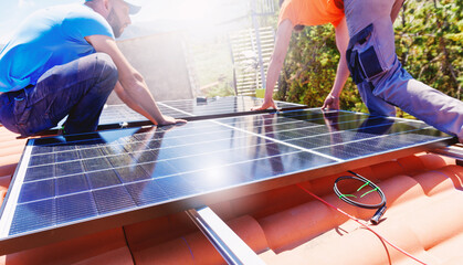 Workers assemble energy system with solar panel for electricity and hot water - obrazy, fototapety, plakaty
