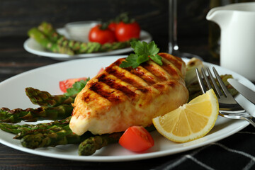 Concept of delicious food with grilled chicken meat on wooden table