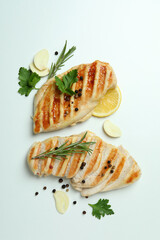 Grilled chicken meat and spices on white background