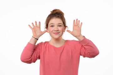 Studio portrait of cheerful young girl making funny face. White background