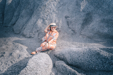 person sitting on a rock