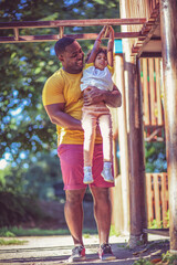 Fototapeta premium Dad and daughter on playground.