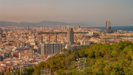 Fototapeta premium Panoramic view over modern and old districts in historical downtown of Barcelona, Spain, cityscape, at summer sunset colors.