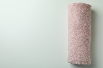 Clean rolled pink towel on white background