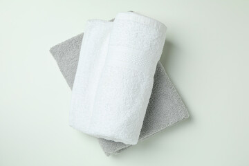 Clean folded towels on white background, top view