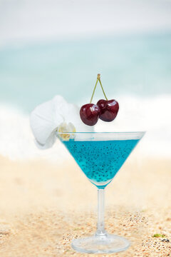 Blue cocktail with chia seeds on the beach overlooking the sea