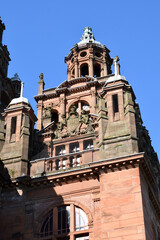 Fototapeta premium Ornate Carvings on Exterior of Public Museum Building against Blue Sky