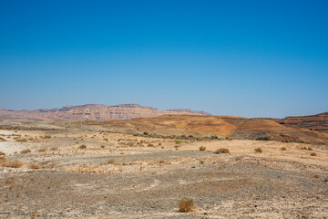 A view from the crater in the Ramon Crater. Arid desert view. White sands and a horizon of blue skies. Negev, Israel. High quality photo