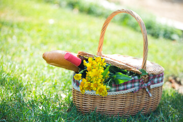 picnic basket with food and flowers