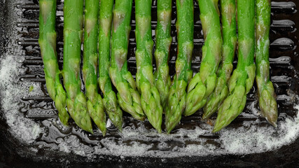 asparagus cooking on grill pan, top view. Healthy food concept