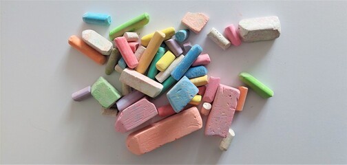 Children's chalks in pastel colors on a white cardboard.