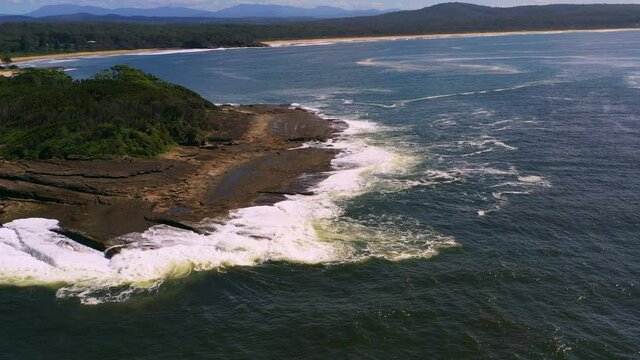 Ocean waves washing over rocky headland