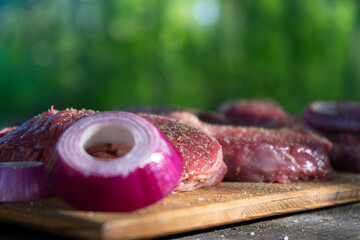 Cooking fresh marbled beef steak at a picnic. Outdoor cooking. Vacations