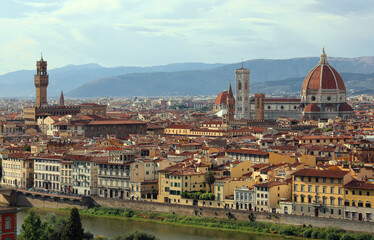 Fototapeta na wymiar Florence in region of Tuscany in Italy with the great Duomo and Palazzo Vecchio seen from Piazzale Michelangelo on the hill and the Arno river