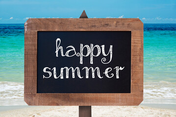 Happy summer sign written on a wooden vintage chalk board, beach background