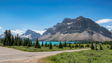 Beautiful turquoise waters of the Bow Lake with snow-covered peaks in Rocky Mountains, Banff...