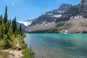 Obraz premium Beautiful turquoise waters of the Bow Lake with snow-covered peaks above it in Rocky Mountains, Banff National Park, Canada. 