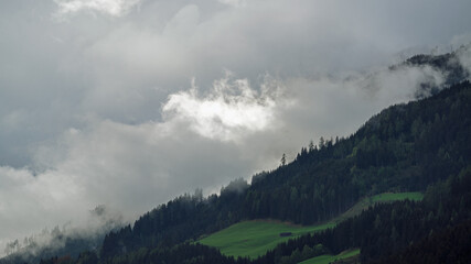 view to the mountains on a rainy and foggy morning