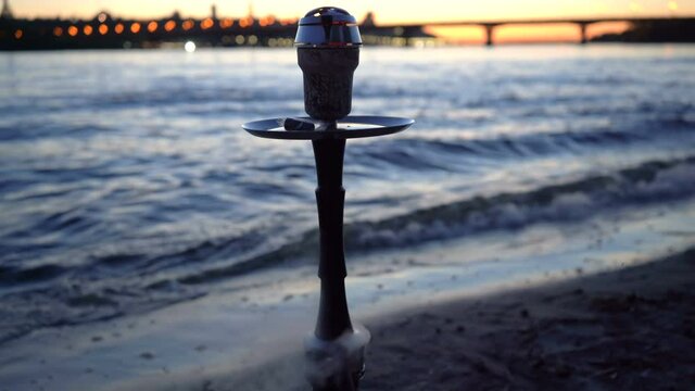 Hookah smoking on the river bank. Sunset on the river