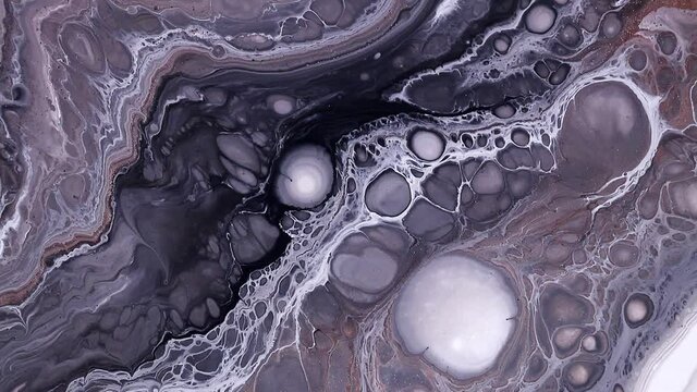 Fluid art drawing video, trendy acryl texture with flowing effect. Liquid paint mixing backdrop with splash and swirl. Detailed background motion with black, white and golden overflowing colors.