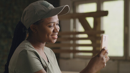 Delighted black military woman speaking with online friend