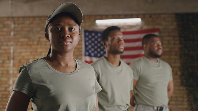 Black Military Woman Standing Near Male Squadmates