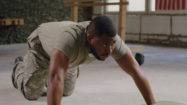 Black Military Man Doing Push Ups In Gym