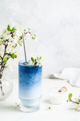Blue matcha latte in a glass.