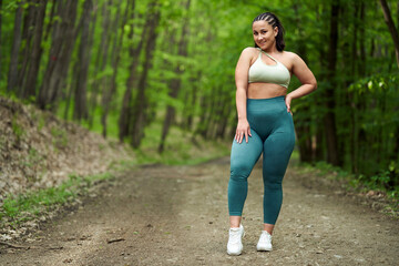 Plus size runner female in the forest