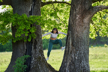 Plus size young woman climbing in a tree