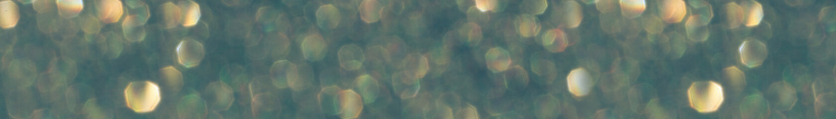 Green glitter bokeh circle glow blurred and blur abstract. Glittering shimmer bright luxury . White and silver glisten twinkle for texture wallpaper and background backdrop.
