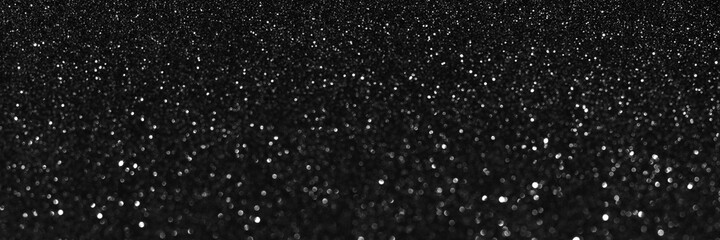 Black glitter bokeh circle glow blurred and blur abstract. Glittering shimmer bright luxury . White and silver glisten twinkle for texture wallpaper and background backdrop.
