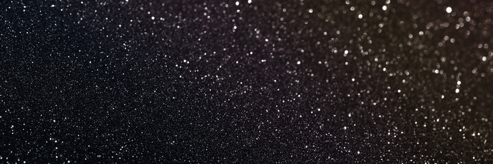 Black glitter bokeh circle glow blurred and blur abstract. Glittering shimmer bright luxury . White and silver glisten twinkle for texture wallpaper and background backdrop.
