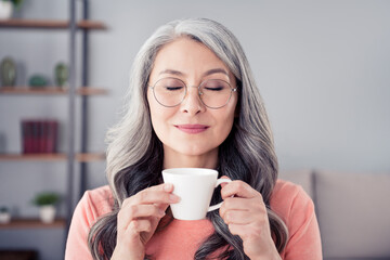 Photo of attractive aged woman happy positive smile enjoy morning hot coffee dream break pause...