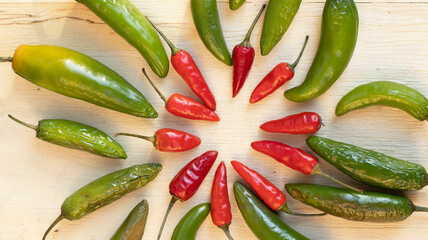 red and green chilies on a wooden board 