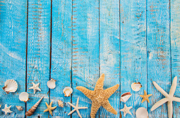 Summer time sea holiday background with star fishes, shells and other beach accessories.