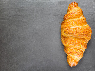  tasty croissant on black stone background. French food. Copy space. Low key