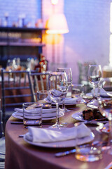 Table setting for a banquet or celebration. Empty wine glasses for spirits, champagne and juice. Set the table. Cloth napkins on a platter. Close-up