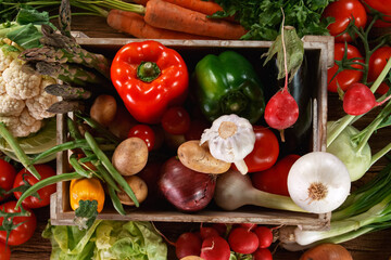 Fresh organic vegetables in a wooden box. Concept for organic raw food