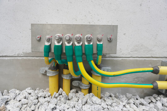 Electrical high voltage ground copper bar on wall. Grounding electric bar. Cables connected to electrical grounding bar, Ground industry for control system.