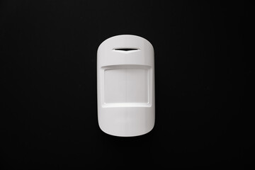 The motion sensor on the black wall. device that tracks the movement of objects.