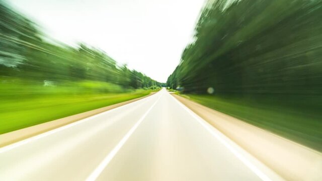 High Speed On The Open Road Fast Car Hyperlapse Point of View Driving on Country Route Through Small Suburbia Town Road Trip Travel Concept Sort of Dashcam POV